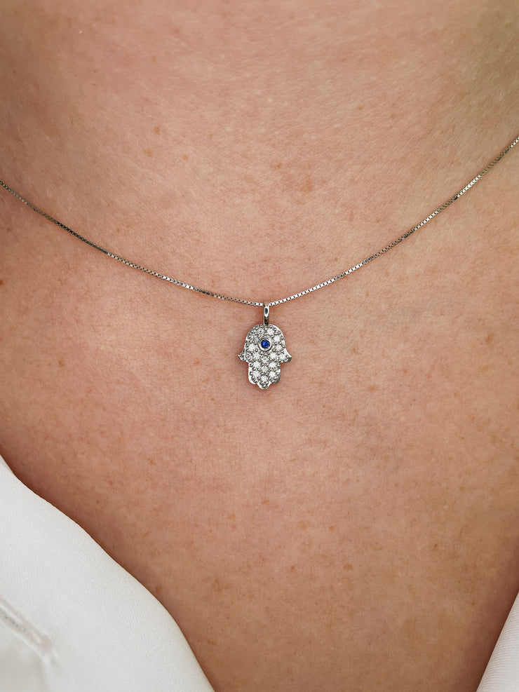 Delicate diamond and sapphire Hamsa pendant.