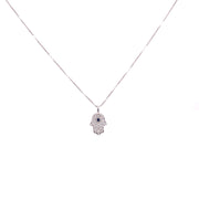 Diamond Hamsa pendant with brilliant blue sapphire at the center.