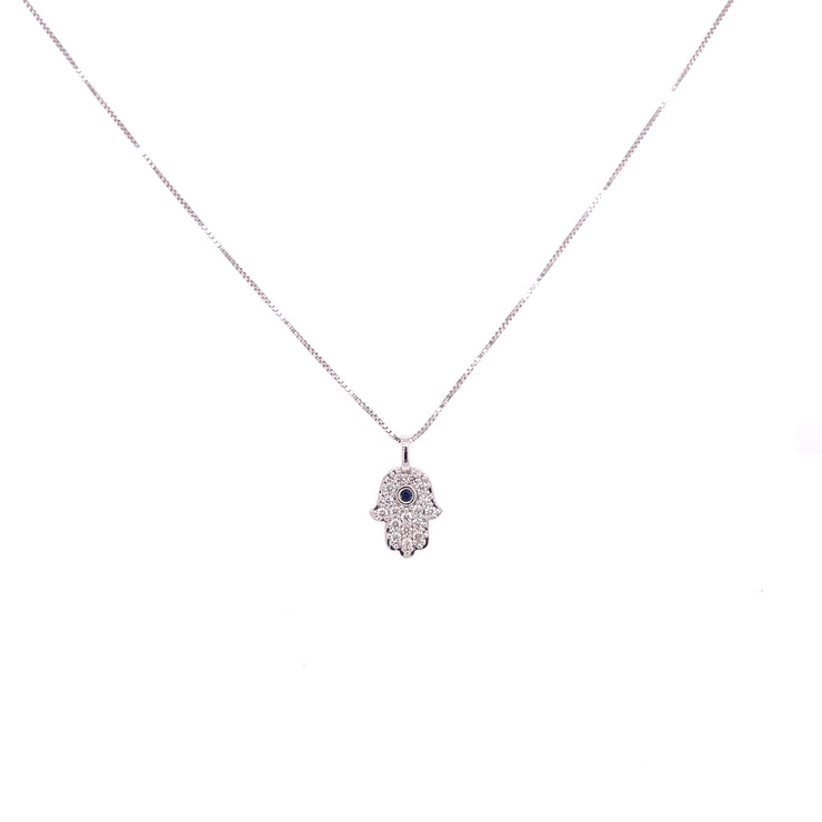 Diamond Hamsa pendant with brilliant blue sapphire at the center.