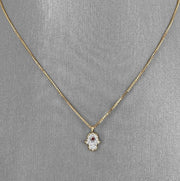 Petite Hamsa pendant in 18K yellow gold.