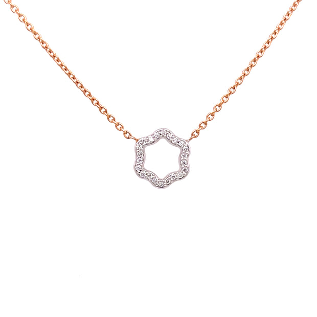 A two-tone diamond necklace featuring a hexagonal design with round brilliant cut diamonds.