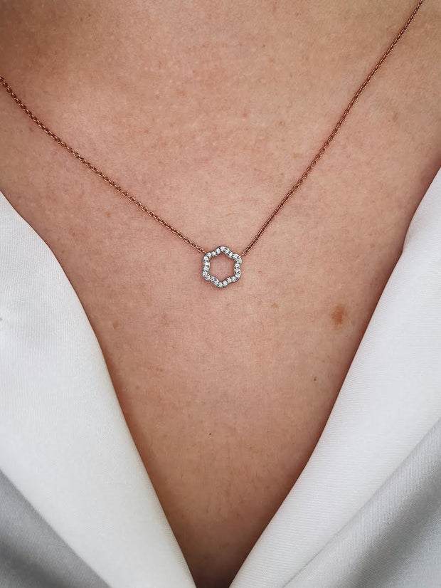 Two-tone 18k gold and diamond hexagonal necklace shown on model.