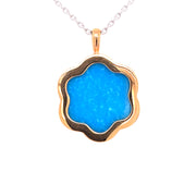 At the center sits 4.12 carats of vivid turquoise.