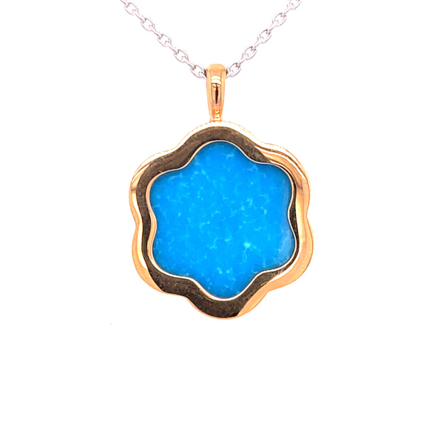 At the center sits 4.12 carats of vivid turquoise.
