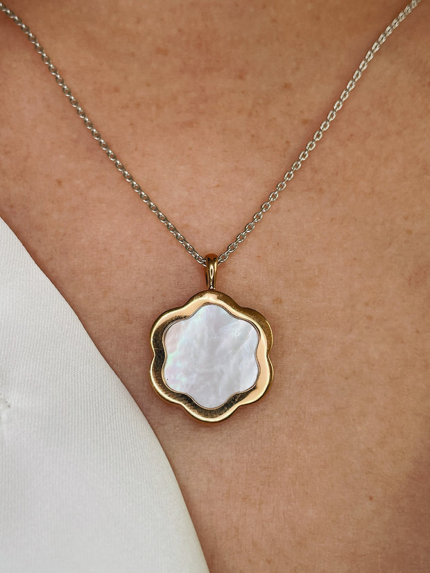 Mother of pearl pendant necklace in luxurious white and yellow gold shown on model.