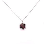 At the center a 2.96 carats of black Mother of Pearl with natural iridescence
and 0.14 carats total weight of round brilliant cut diamond accents.