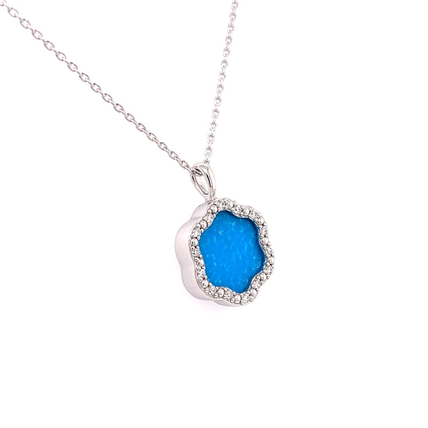  3.14 carats of vibrant turquoise with 0.14 carats total weight of round brilliant cut diamond accents.