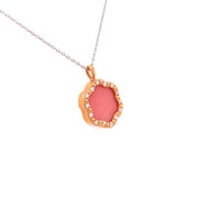 With 3.45 carats of soft, luminous pink opal at center and 0.21 carats total weight of round brilliant cut diamond accents.
