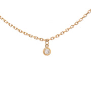 A close up view of the bezel set diamond.