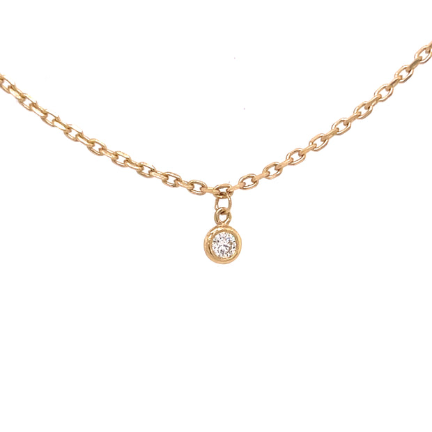 A close up view of the bezel set diamond.