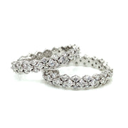 A refined view of the craftsmanshop in earch diamond set in these stunning diamond hoop earrings.