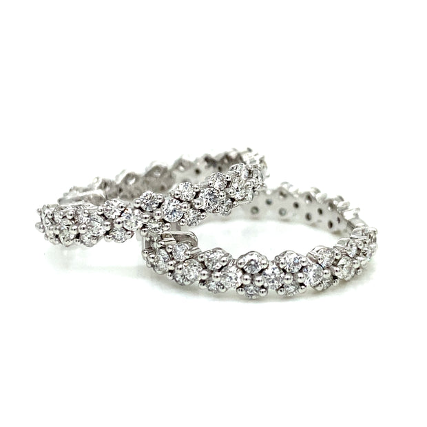 A refined view of the craftsmanshop in earch diamond set in these stunning diamond hoop earrings.