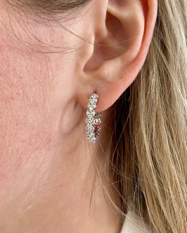 Stunning diamond hoops shown on model.