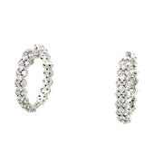 A pair of 18K white gold hoop earrings with round brilliant cut diamonds.