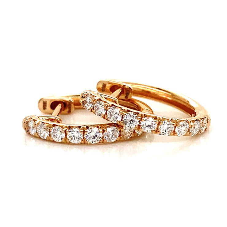 Natural round brilliant diamonds set in rose gold mini hoop earrings.