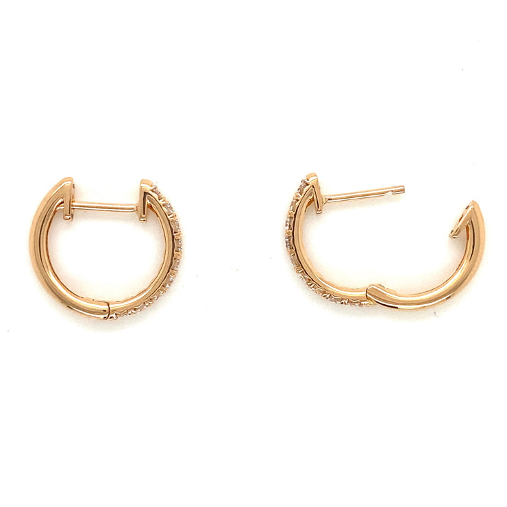 Mini diamond hoop earrings shown from the side.