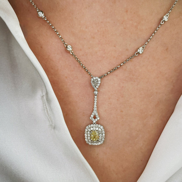 Fancy yellow diamond dro pendant shown in detail n model.