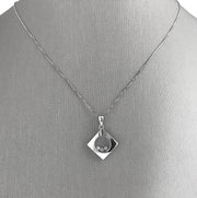 Three round brilliant cut diamonds totaling 0.06 carats, The  diamonds float freely for captivating movement and light play.