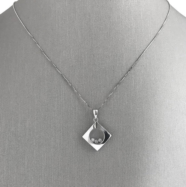 Three round brilliant cut diamonds totaling 0.06 carats, The  diamonds float freely for captivating movement and light play.