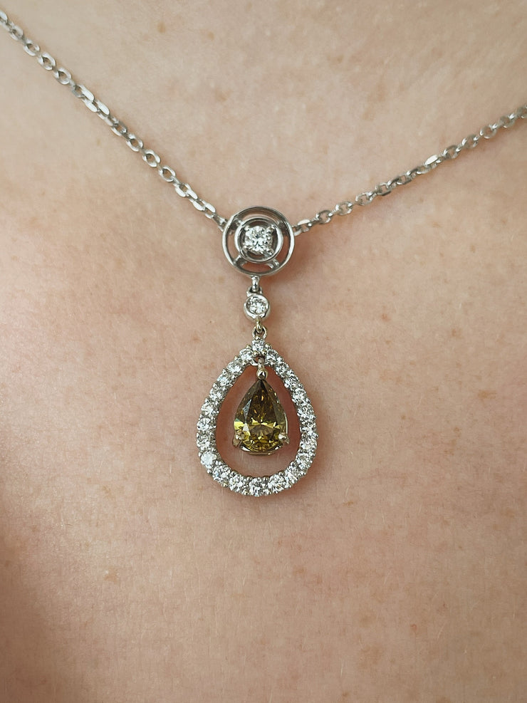 A stunning close look at the green diamond pendant on model.