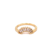 A baguette shaped diamond ring enhancer set in a 14 karat yellow gold. band