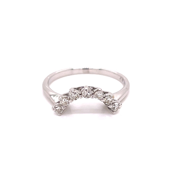 An arched diamond ring enhancer set in a white gold band, featuring round brilliant cut diamonds.