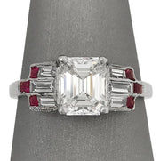This stunning Art Deco ring features a 1.1ct emerald cut diamond and 0.4ct of baguette diamonds, accented with delicate milgrain detailing. Set in platinum.