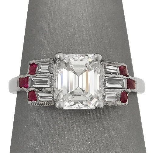 This stunning Art Deco ring features a 1.1ct emerald cut diamond and 0.4ct of baguette diamonds, accented with delicate milgrain detailing. Set in platinum.