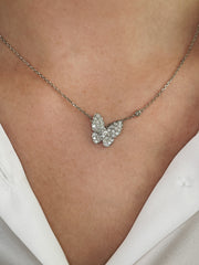 Delicate diamond butterfly necklace shown on model.