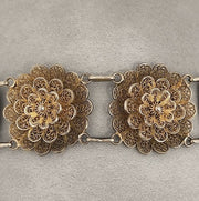 Fine craftsmenship in this beautifully detailed gold floral link bracelet.