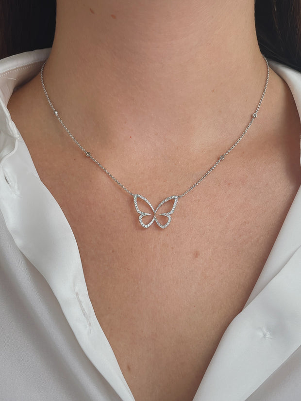 Beautifully delicate butterfly diamond necklace on model.