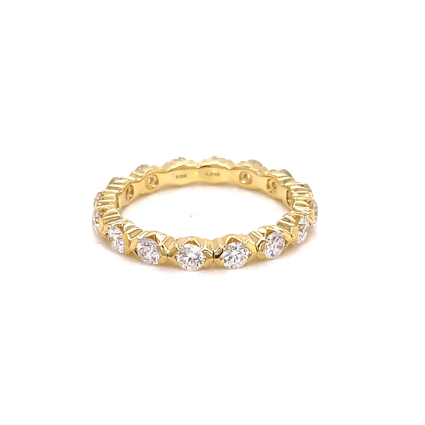 A yellow gold eternity band ring with round brilliant cut diamonds set in it.