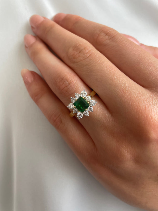 Beautifully Crafted Emerald and Diamond Ring Designed to Resemble a Flower shown on a model's hand.