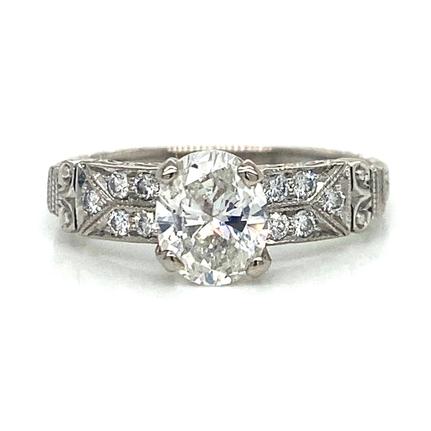 Front view showcasing the oval diamond framed by petite side stones.