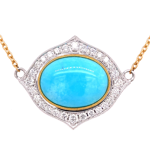 Stunning turquoise cabacheon with round brilliant diamonds surrounding.