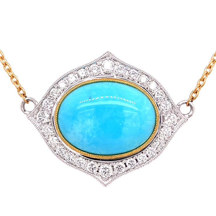 Stunning turquoise cabacheon with round brilliant diamonds surrounding.