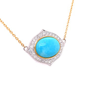 A side view of the two tone gold turquoise pendant.