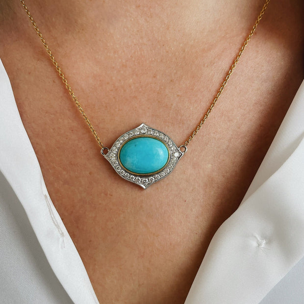 Unique diamond halo suurounds this natural turquoise cabachon. 