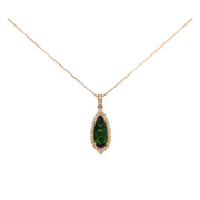 A detail look at the deep hue of the green tourmaline set in rose gold.