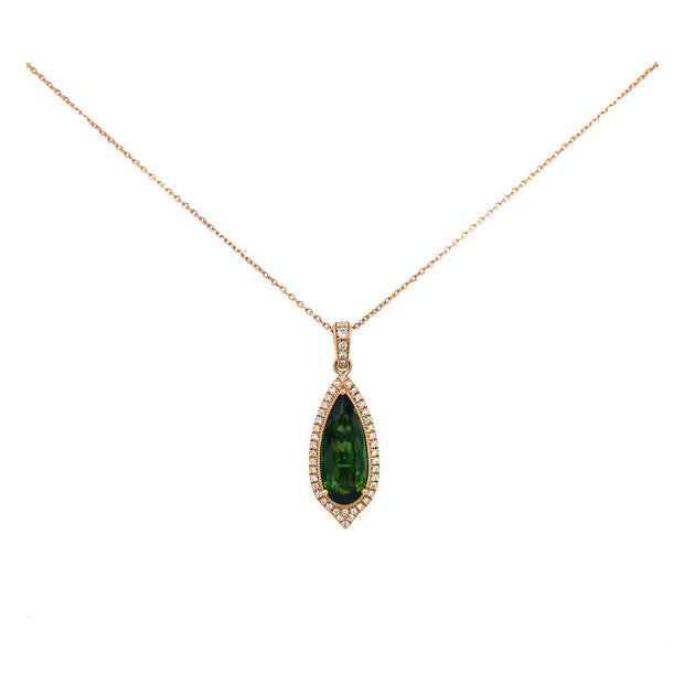 A detail look at the deep hue of the green tourmaline set in rose gold.