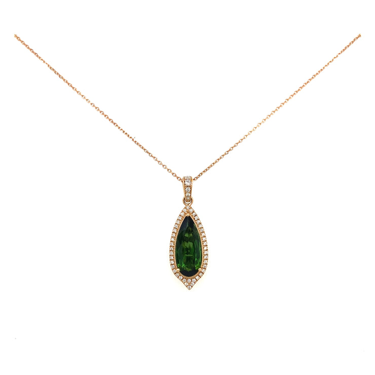 A detail look at the deep hue of the green tourmaline set in rose gold.
