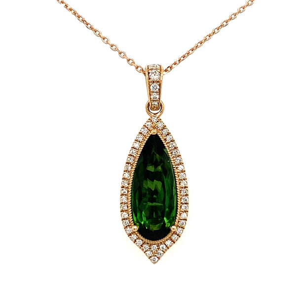 A pear-shaped green tourmaline necklace with a diamond halo and bail set in 18k rose gold.