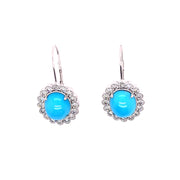 A pair of turquoise earrings witha natural diamond halo set in 18K white gold.