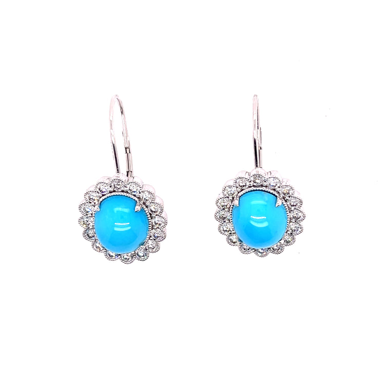 A pair of turquoise earrings witha natural diamond halo set in 18K white gold.