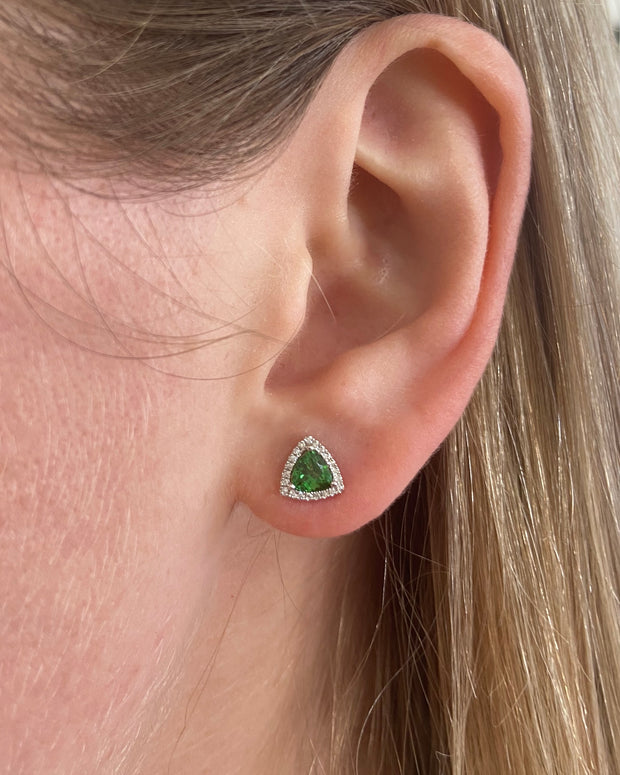 Tsavorite and diamond halo stud earring shown on model.
