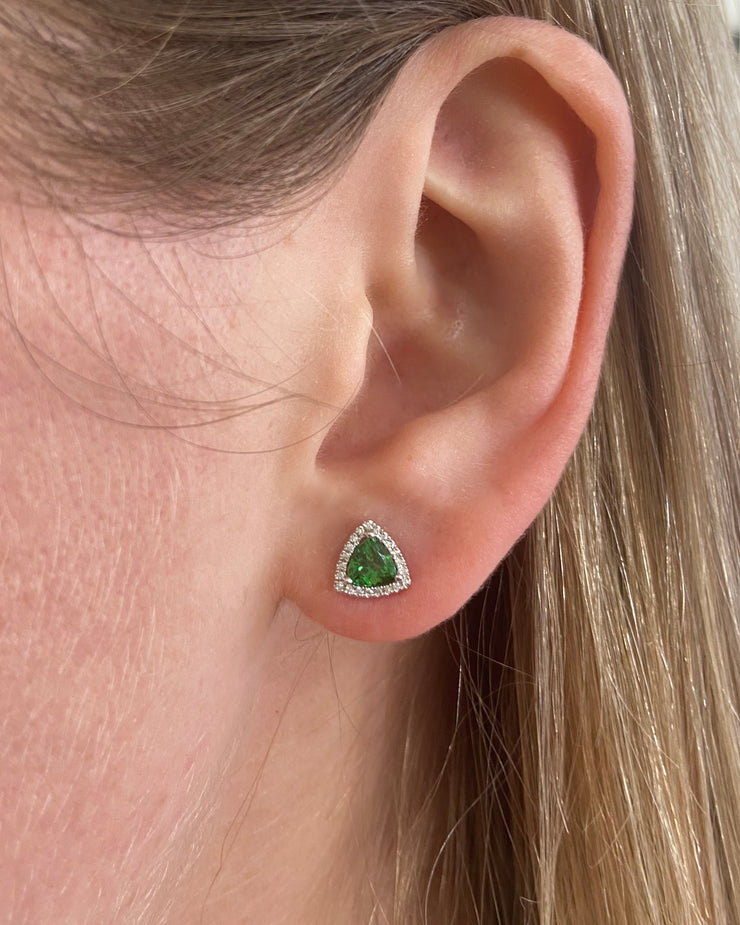 Tsavorite and diamond halo stud earring shown on model.