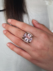 15.37 carat cushion-cut kunzite with a delicate pink hue and remarkable brilliance seen here on model.