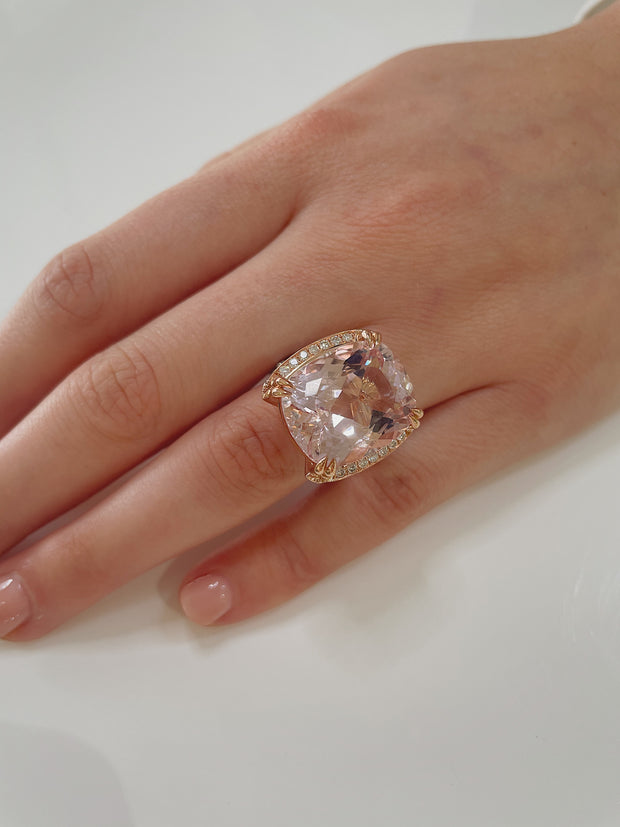 A close look at the luminous pink kuzite center stone shoen here on model.