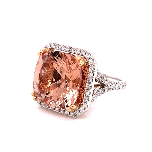 An 18k rose and white gold ring featuring a cushion cut morganite weighing 14.14 cts, adorned with round faceted pink sapphires and a pave of round brilliant diamonds.