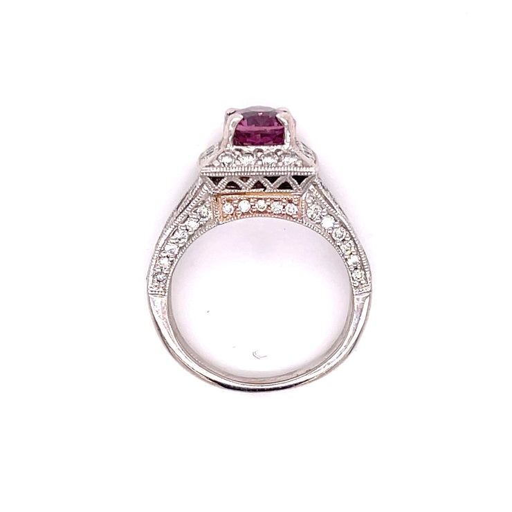 Pink sapphire and diamond ring shown at an angle showcasing the side diamonds.